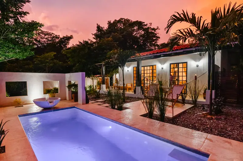 Villa Mariposa at dusk, the pool lit
