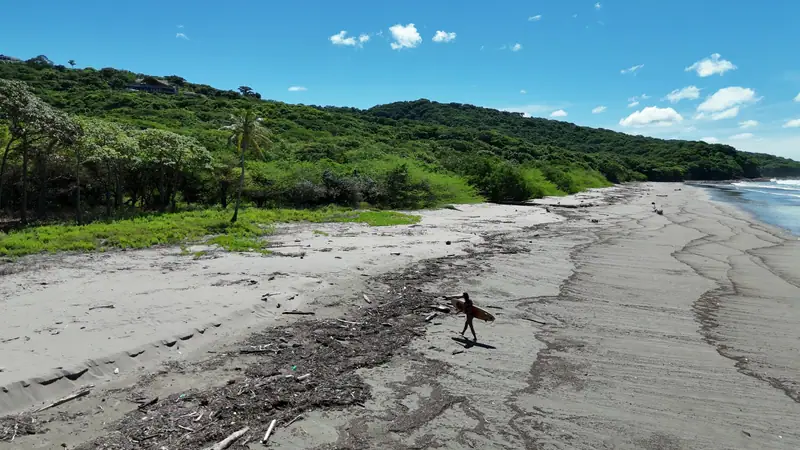 Playa Yankee, a surfer walking on the sand